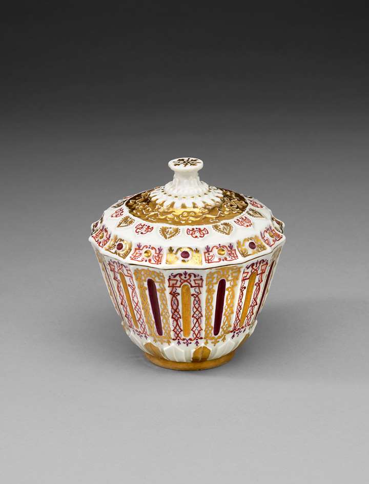 A covered sugar bowl with relief decoration
